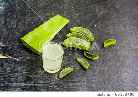 Aloe vera pieces and aloe gel in the glass on an old dark wood background Organic cosmetics concept Aloe vera pieces and aloe gel in the glass on an old dark wood background Organic cosmetics concept 66153490