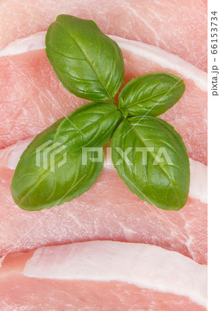 Slices of fresh loin with basil Slices of fresh loin with basil 66153734
