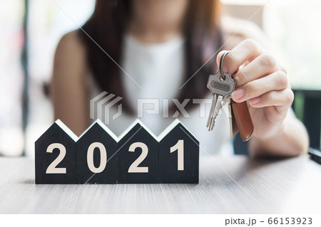 Young Businesswoman hands holding key and wooden 66153923