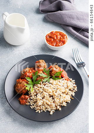Beef meatballs and brown rice on a plate. Ready made portioned dish meat with garnish. Copy space. 66154643