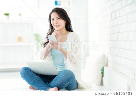 女性がスマホとパソコンを操作している 女性がスマホとパソコンを操作している 66155403