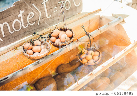 Hot natural underground thermal water is used to boil chicken eggs in some volcanic activity area. 66159495