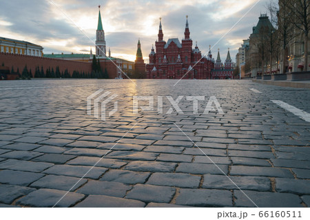 Back lit photography. Coronavirus pandemic. Quarantine, streets without people. Red Square, Kremlin Towers, State Historical Museum, GUM (Central Department Store). Gloomy sky over the city 66160511