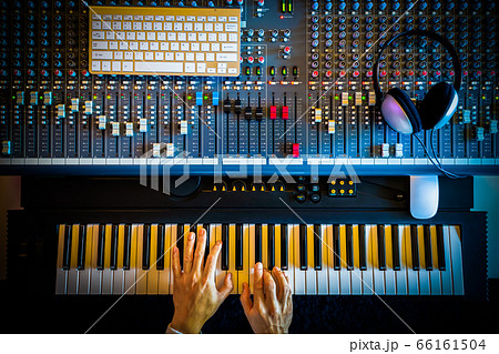 top view of music producer hands playing midi piano for recording in sound studio top view of music producer hands playing midi piano for recording in sound studio 66161504