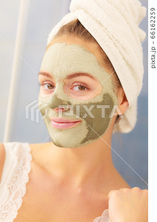 Woman face with green clay mud mask Woman face with green clay mud mask 66162259
