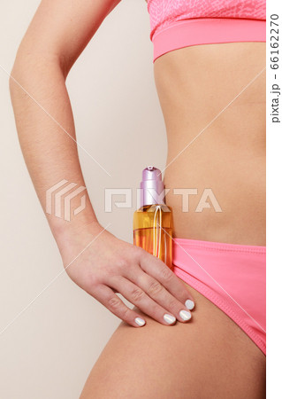 Woman applying moisturizing body oil lotion 66162270