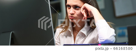 Pretty overworked woman at workplace 66168580