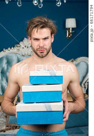 Man in luxury bedroom with gift box. Man handsome Man in luxury bedroom with gift box. Man handsome 66171794
