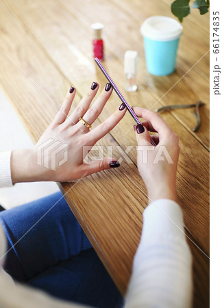 Woman making manicure at home 66174835