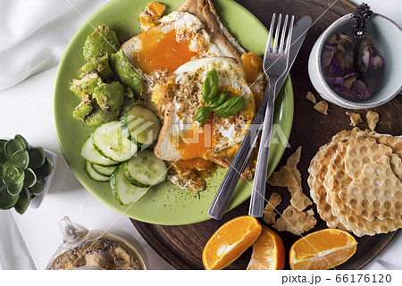 Fried eggs with toasts and tea in bed Fried eggs with toasts and tea in bed 66176120