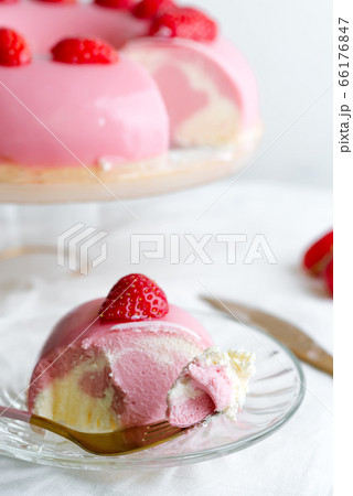 Fork with piece of homemade soft taste dessert on a glass plate from fresh natural fruits on a white textile table. 66176847