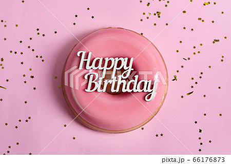 Text Happy Birthday above freshly cooked homemade fruit glazed dessert on a pink background with decoration. 66176873