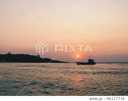 Silhouette fisherman boat with the sunset scene for background concept 66177716