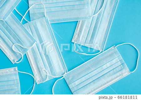Medical protective masks on a blue background. Disposable 3-ply medical mask to cover the mouth and nose to prevent coronavirus. Coronavirus quarantine. Antivirus medical mask for protection covid-19. 66181811