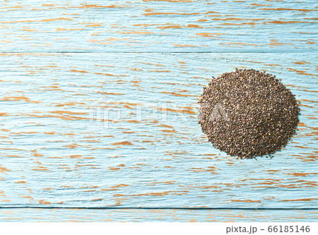 chia seeds on a blue wooden table, top view with chia seeds on a blue wooden table, top view with 66185146
