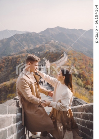 beautiful young couple showing affection on the Great Wall of China 66194164