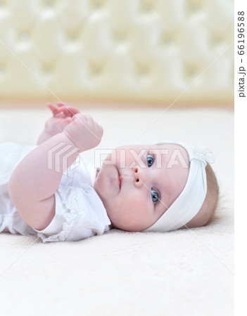 Cute little baby girl against light background Cute little baby girl against light background 66196588
