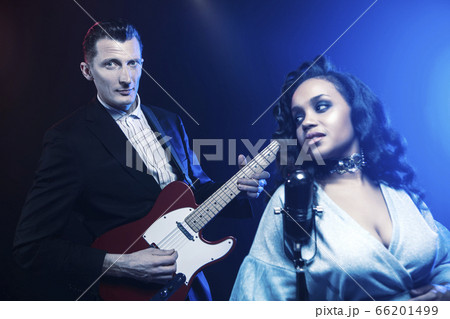A jazz singer performs on stage. Afro. 66201499