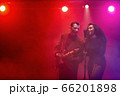 A jazz singer and guitarist perform on stage. 66201898