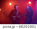 A jazz singer and guitarist perform on stage. 66201901