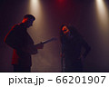 A jazz singer and guitarist perform on stage. 66201907