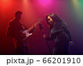 A jazz singer and guitarist perform on stage. 66201910