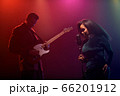 A jazz singer and guitarist perform on stage. 66201912