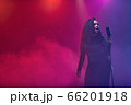A jazz singer performs on stage. Afro. 66201918