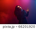A jazz singer performs on stage. Afro. 66201920