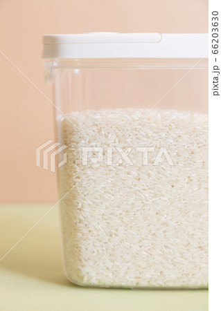 Plastic transparent container with rice on a green background. Plastic transparent container with rice on a green background. 66203630