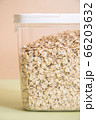 Plastic transparent container with oatmeal on a green background. 66203632