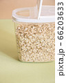 Plastic transparent container with oatmeal on a green background. 66203633