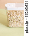 Plastic transparent container with oatmeal on a green background. 66203634
