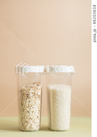 Plastic containers with cereals. Home storage products. Rice and oat. Plastic containers with cereals. Home storage products. Rice and oat. 66203638