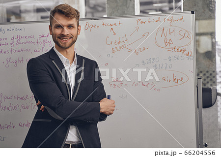 Cheerful young businessman posing for the camera 66204556