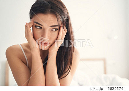 Young woman suffering from headache in the morning 66205744