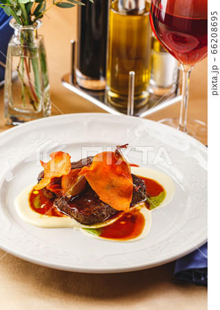 Beef tenderloin medallions with sauce and onion Beef tenderloin medallions with sauce and onion 66208695