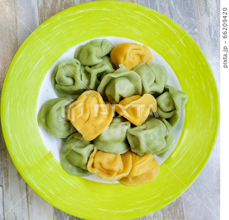 the dish is made from multicolored dumplings on a plate. children's menu the dish is made from multicolored dumplings on a plate. children's menu 66209420