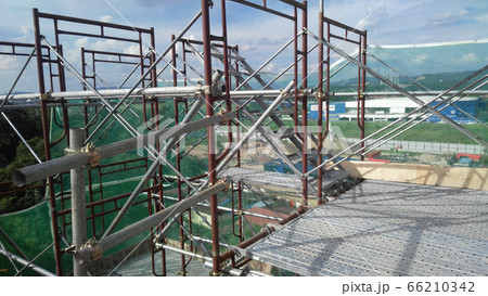 MALACCA, MALAYSIA -SEPTEMBER 23, 2016: Temporary access and staircase supported by reinforced scaffolding at the construction site. Used by construction workers. MALACCA, MALAYSIA -SEPTEMBER 23, 2016: Temporary access and staircase supported by reinforced scaffolding at the construction site. Used by construction workers. 66210342