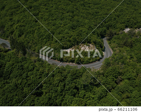 Mountain winding zig zag road. Top aerial view: cars driving on road from above. 66211106