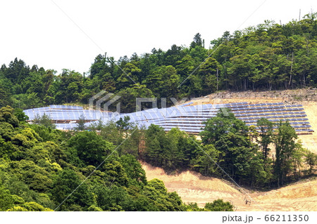 山を削って設置されたメガソーラーと緑の木々 工事途中の写真素材