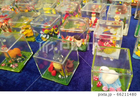 KUALA LUMPUR, MALAYSIA -SEPTEMBER 23, 2016: Miniature models and cartoon characters are made using plastic clay and placed in perspex containers. KUALA LUMPUR, MALAYSIA -SEPTEMBER 23, 2016: Miniature models and cartoon characters are made using plastic clay and placed in perspex containers. 66211480