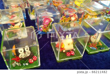 KUALA LUMPUR, MALAYSIA -SEPTEMBER 23, 2016: Miniature models and cartoon characters are made using plastic clay and placed in perspex containers. 66211482