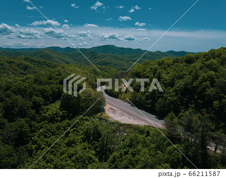Mountain winding zig zag road. Top aerial view: cars driving on road from above. Mountain winding zig zag road. Top aerial view: cars driving on road from above. 66211587
