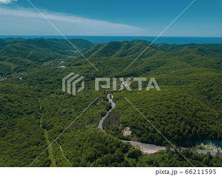 Mountain winding zig zag road. Top aerial view: cars driving on road from above. Mountain winding zig zag road. Top aerial view: cars driving on road from above. 66211595