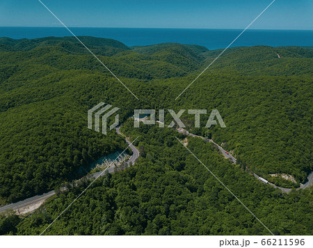 Mountain winding zig zag road. Top aerial view: cars driving on road from above. 66211596