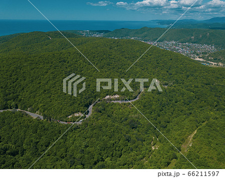 Mountain winding zig zag road. Top aerial view: cars driving on road from above. 66211597