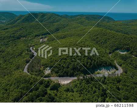 Mountain winding zig zag road. Top aerial view: cars driving on road from above. Mountain winding zig zag road. Top aerial view: cars driving on road from above. 66211598