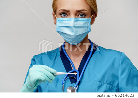 medical doctor nurse woman with stethoscope wearing protective mask and rubber or latex gloves holding thermometer medical doctor nurse woman with stethoscope wearing protective mask and rubber or latex gloves holding thermometer 66214622