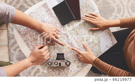 Couple Sitting With Map Choosing Destination For Vacation, Cropped, Above-View 66219977